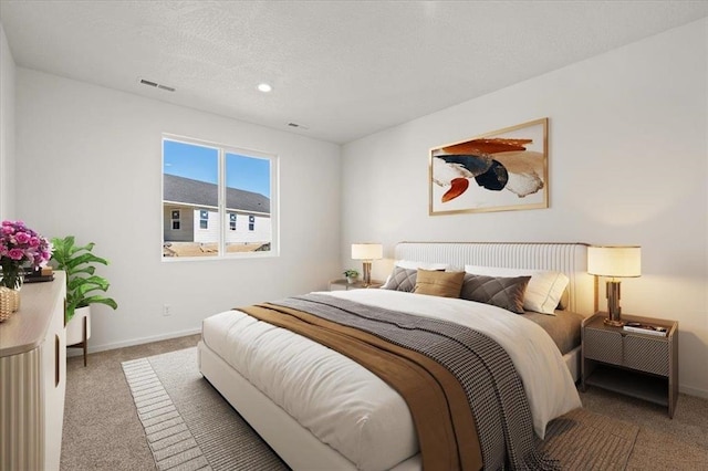 carpeted bedroom with a textured ceiling