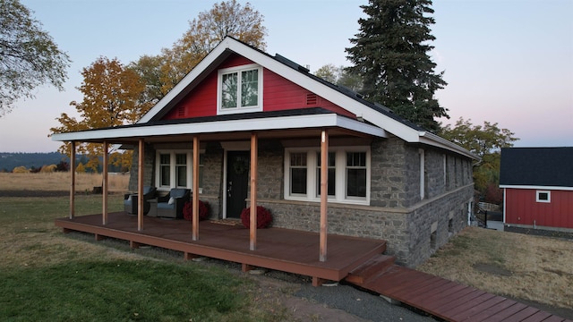 view of front of house featuring a yard and a shed