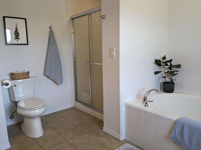 bathroom featuring plus walk in shower, tile patterned flooring, and toilet