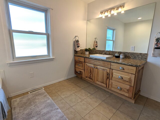 bathroom featuring tile patterned floors, vanity, and a wealth of natural light