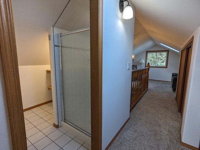 hall featuring light colored carpet and lofted ceiling