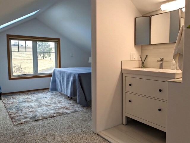 bathroom featuring vanity and vaulted ceiling