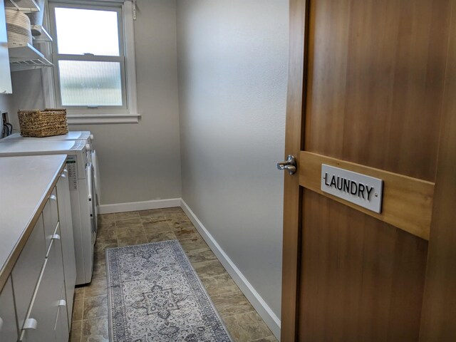 laundry room featuring washing machine and dryer and cabinets