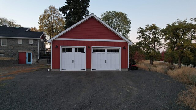 view of garage at dusk