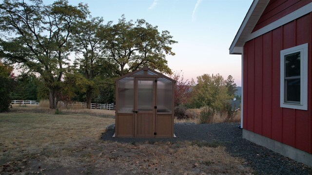 outdoor structure at dusk with a yard