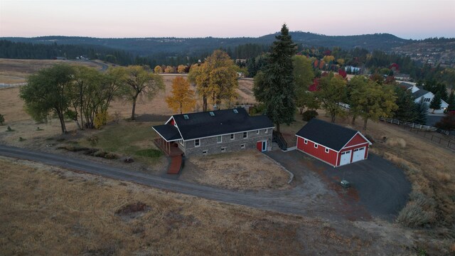 aerial view at dusk featuring a rural view