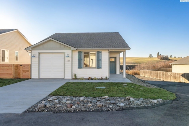 single story home featuring a front yard and a garage