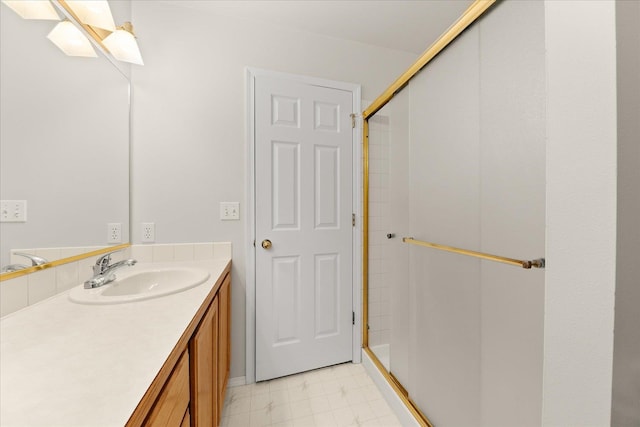 bathroom featuring vanity and a shower with door