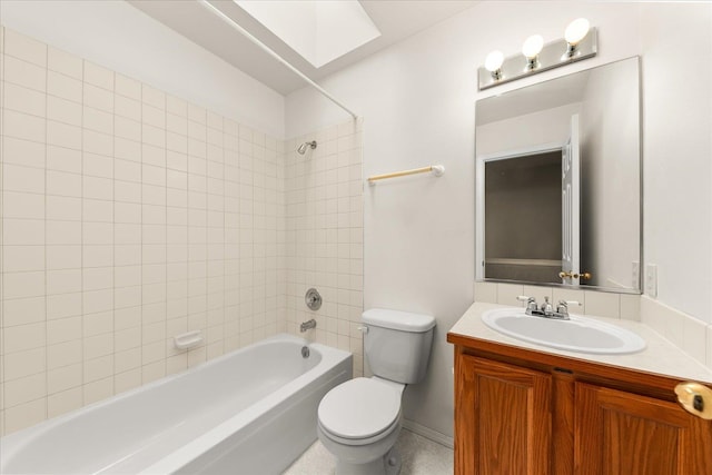 full bathroom with vanity, toilet, and tiled shower / bath