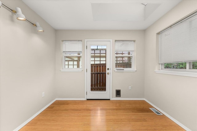 doorway to outside with light hardwood / wood-style floors and a wealth of natural light