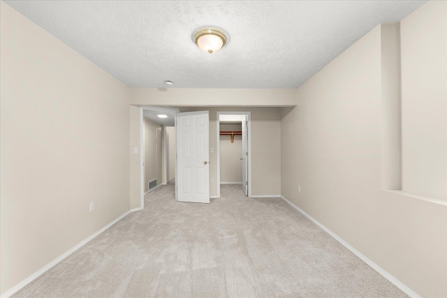 4815 S Kip Ln, Spokane, WA 99224 - unfurnished bedroom featuring a textured ceiling, light carpet, baseboards, a walk in closet, and a closet
