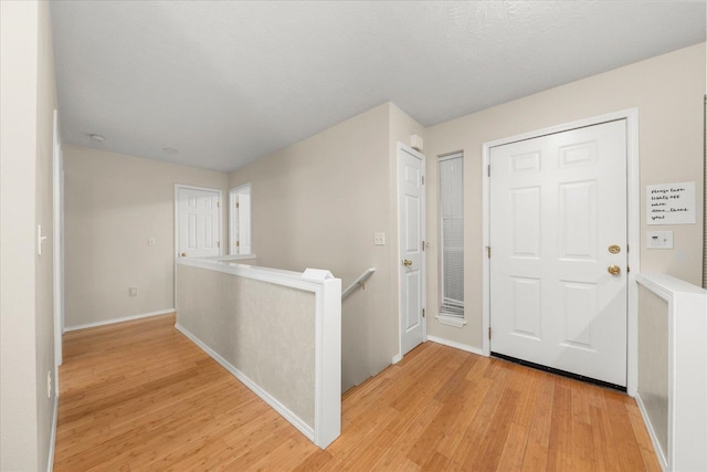 entryway featuring light hardwood / wood-style floors and a textured ceiling