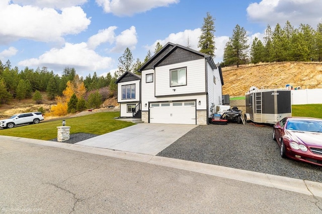 view of property with a garage and a front yard