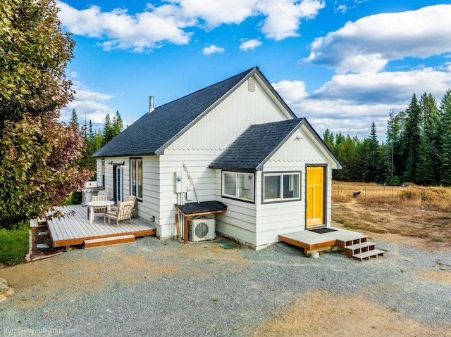 back of house with ac unit and a deck