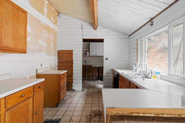 kitchen featuring wood ceiling, wooden walls, sink, light tile patterned floors, and lofted ceiling with beams