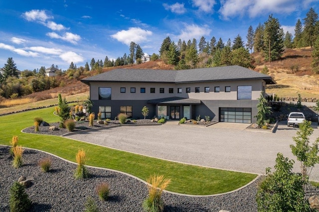 view of front of property with a garage and a front lawn