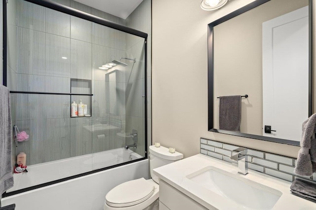 full bathroom featuring vanity, toilet, enclosed tub / shower combo, and backsplash