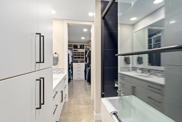 bathroom with vanity and tasteful backsplash