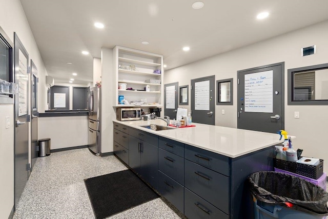 kitchen with a breakfast bar area, sink, a kitchen island, and stainless steel appliances