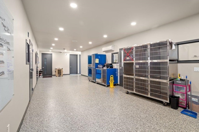 garage with a wall mounted air conditioner