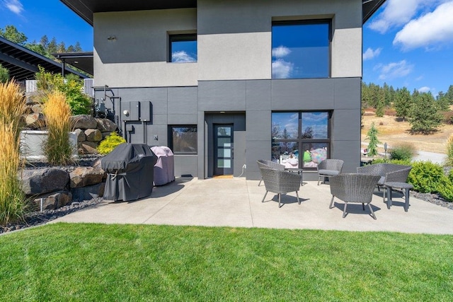 back of house featuring a lawn and outdoor lounge area