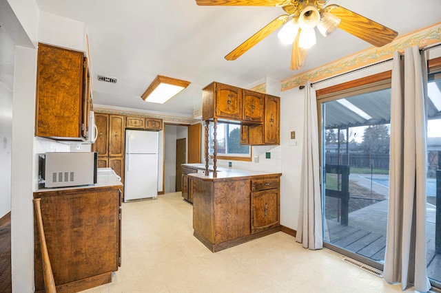 kitchen featuring white appliances, ceiling fan, and ornamental molding