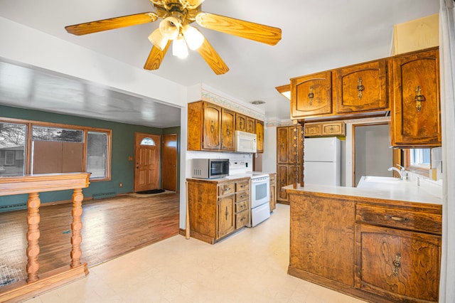 kitchen with ceiling fan, light hardwood / wood-style floors, white appliances, and sink