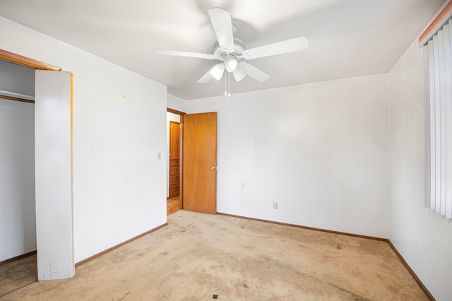 unfurnished bedroom featuring ceiling fan, light colored carpet, and a closet