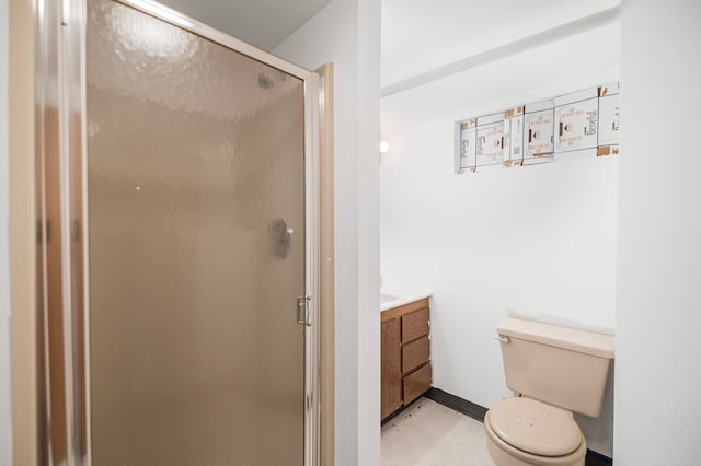 bathroom featuring vanity, toilet, and an enclosed shower