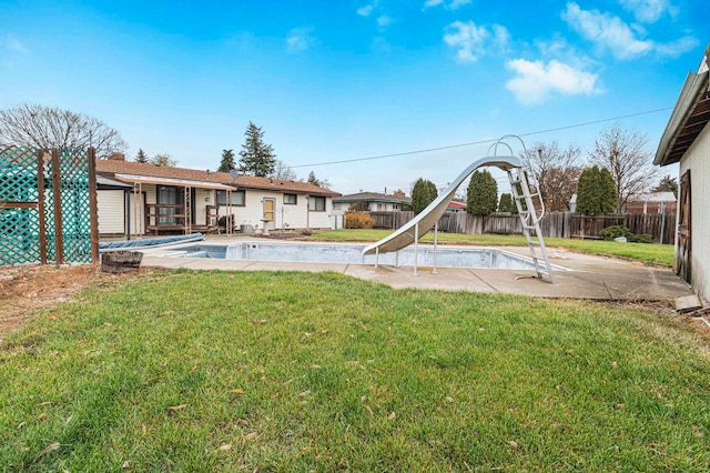 view of yard with a fenced in pool and a patio