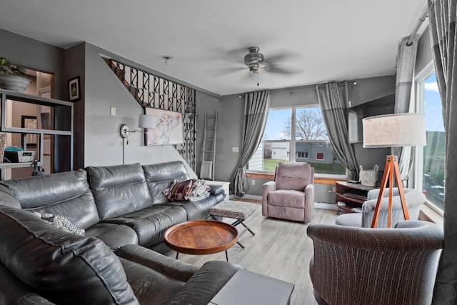 living room featuring ceiling fan and light hardwood / wood-style floors