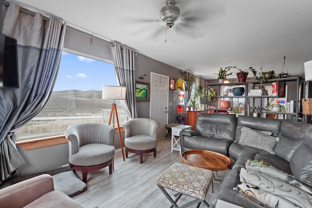 living room featuring ceiling fan and light hardwood / wood-style floors