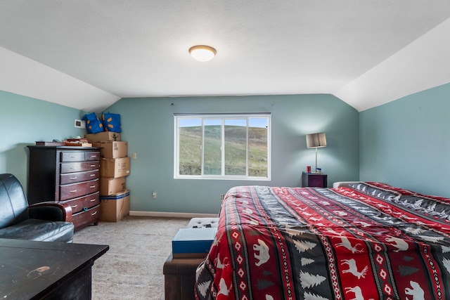 bedroom with lofted ceiling and light carpet