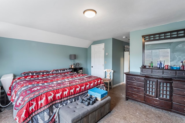 carpeted bedroom featuring lofted ceiling