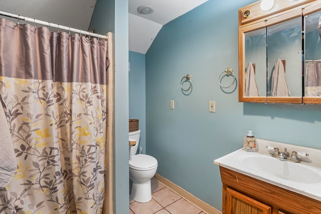 bathroom featuring toilet, vanity, tile patterned floors, and lofted ceiling