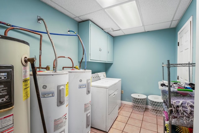 laundry area with independent washer and dryer, cabinets, electric water heater, and water heater