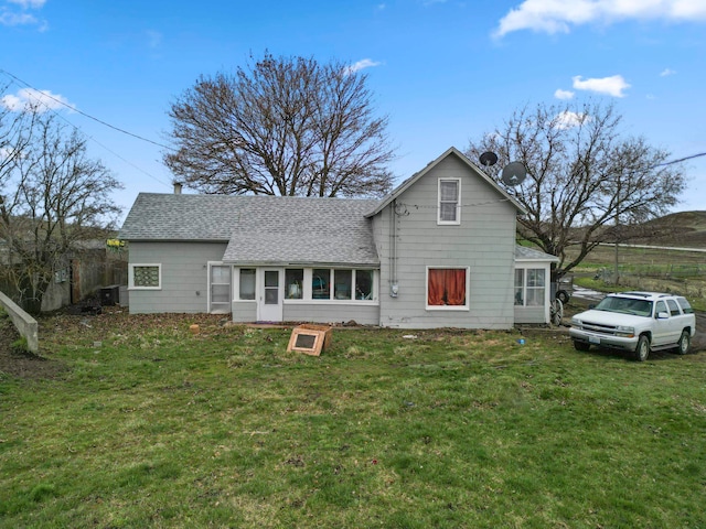 back of property featuring a lawn