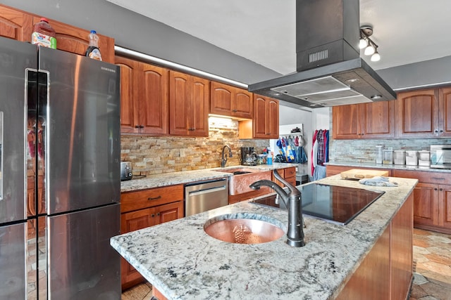 kitchen with light stone countertops, tasteful backsplash, island exhaust hood, an island with sink, and appliances with stainless steel finishes