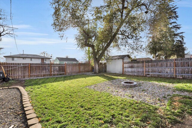 view of yard with a fire pit