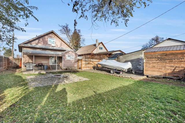 rear view of property featuring a lawn