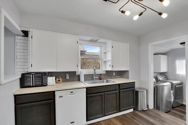 kitchen featuring dishwasher, dark wood-type flooring, white cabinets, sink, and separate washer and dryer