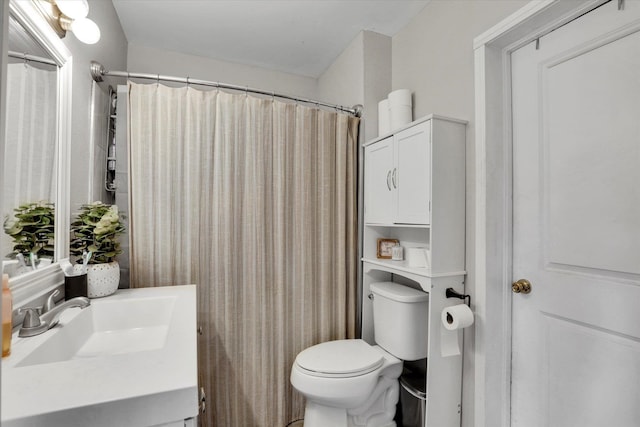 bathroom featuring vanity, curtained shower, and toilet