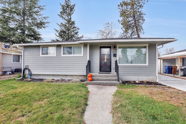 view of front of home with a front lawn and cooling unit