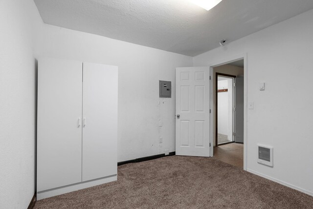 spare room with carpet floors and a textured ceiling