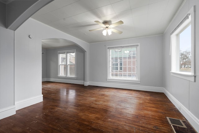 spare room featuring dark hardwood / wood-style flooring, ceiling fan, and ornamental molding