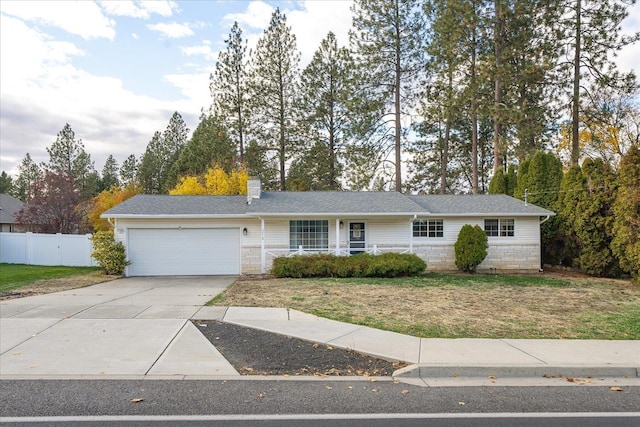 ranch-style home featuring a garage and a front lawn