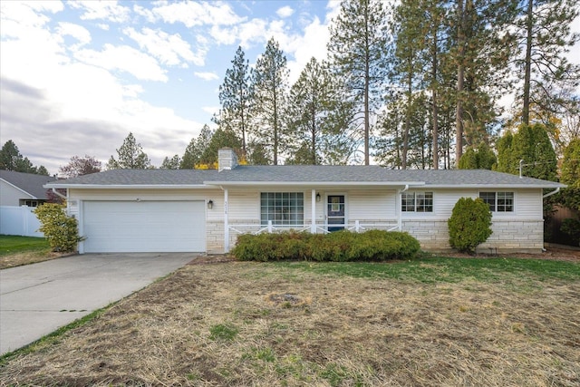 ranch-style house with a front lawn, a porch, and a garage