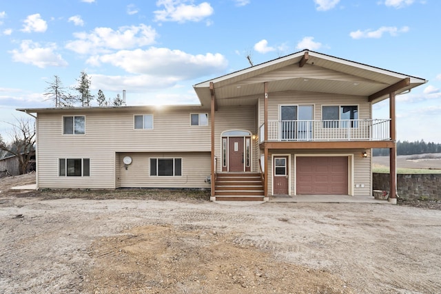 raised ranch with a garage and a balcony