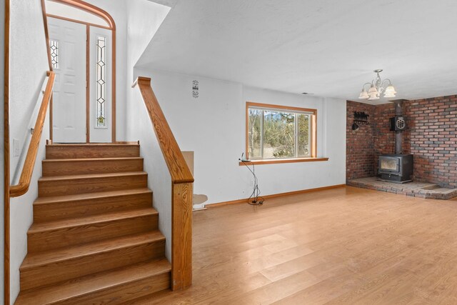 stairway featuring hardwood / wood-style flooring and a wood stove