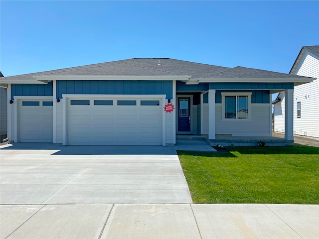 view of front of house with a front yard and a garage